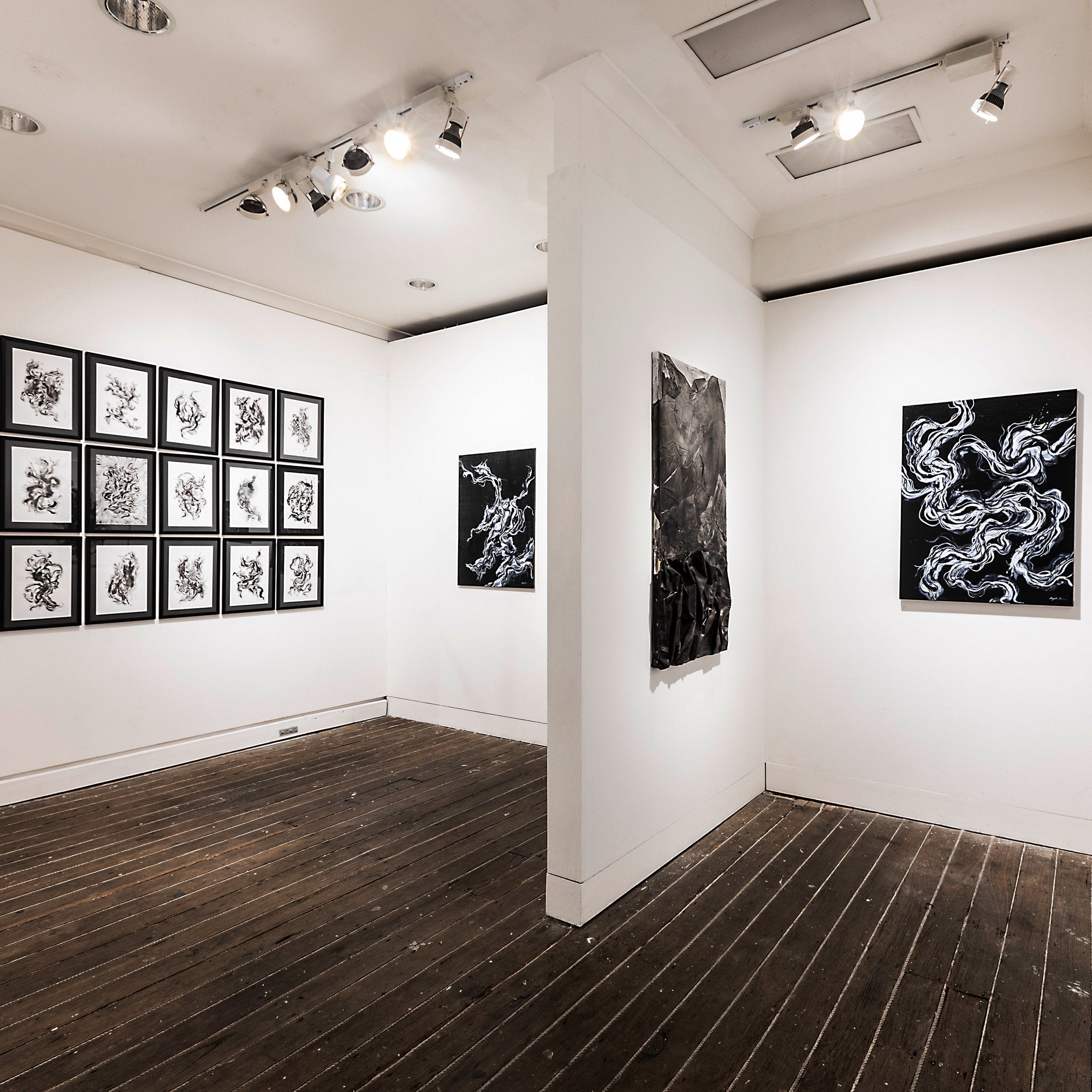 Abstract figurative black and white paintings adorn the gallery space at Gaffa Gallery in Sydney. Artworks created by Australian-Chinese artist Angela Tam.