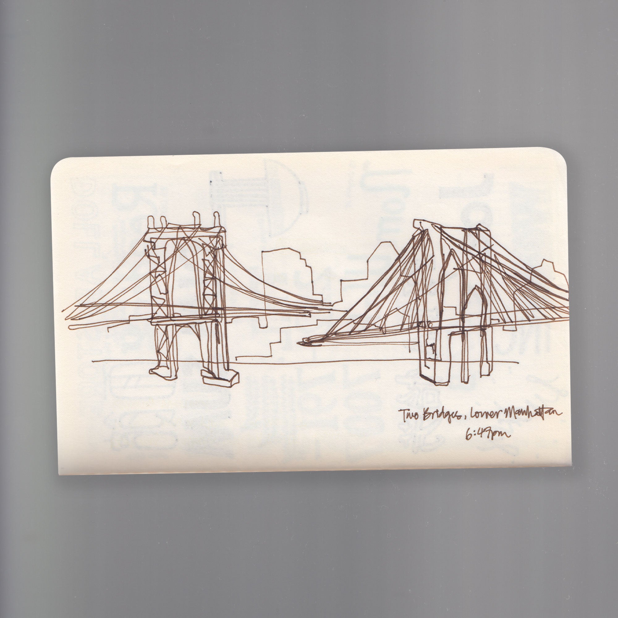 A sketch of the two bridges overlooking Manhattan, drawn on a moleskin notebook by Angela Tam.