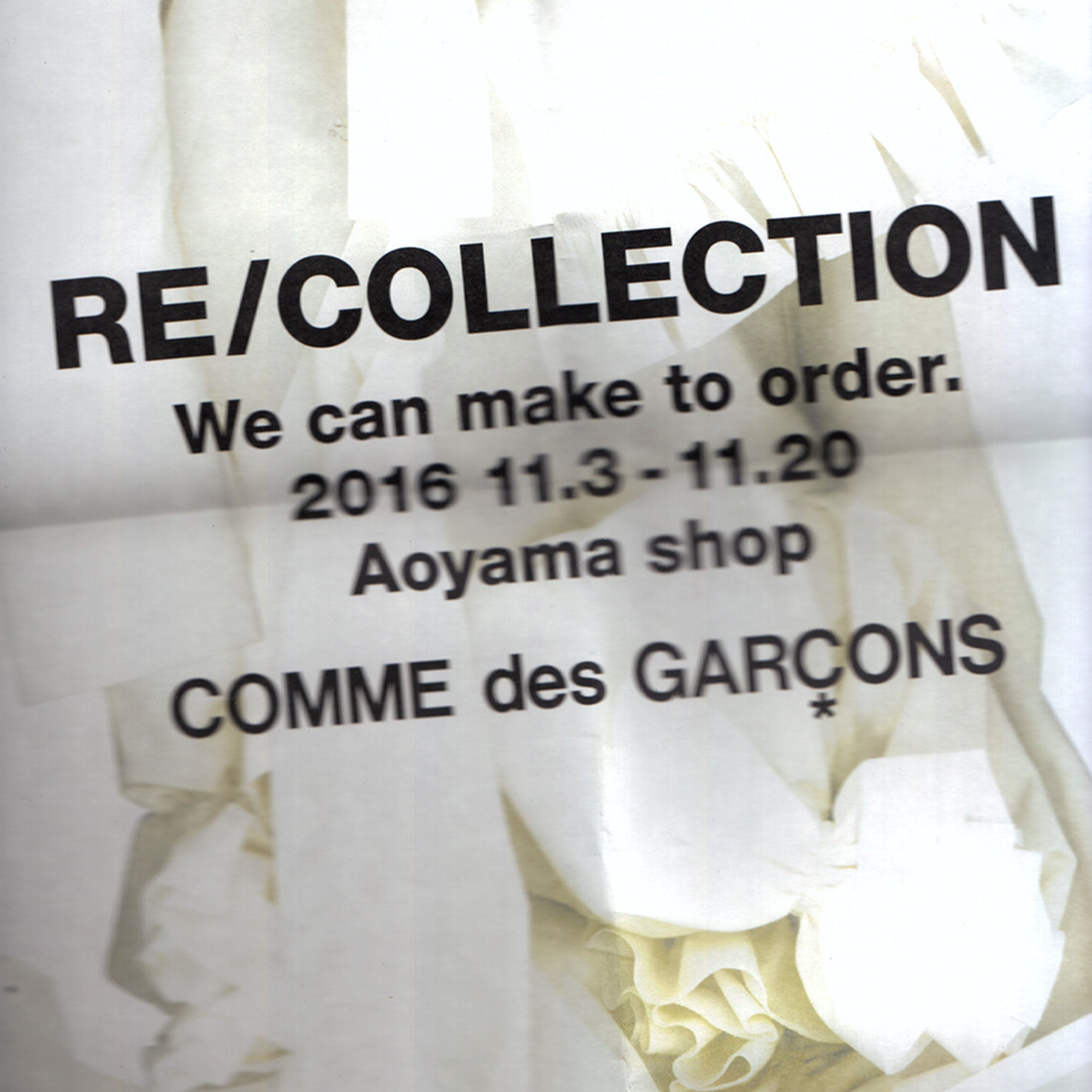 A scanned folded and distorted white image with the text "Re/Collection Comme des Garcons" printed on the paper.