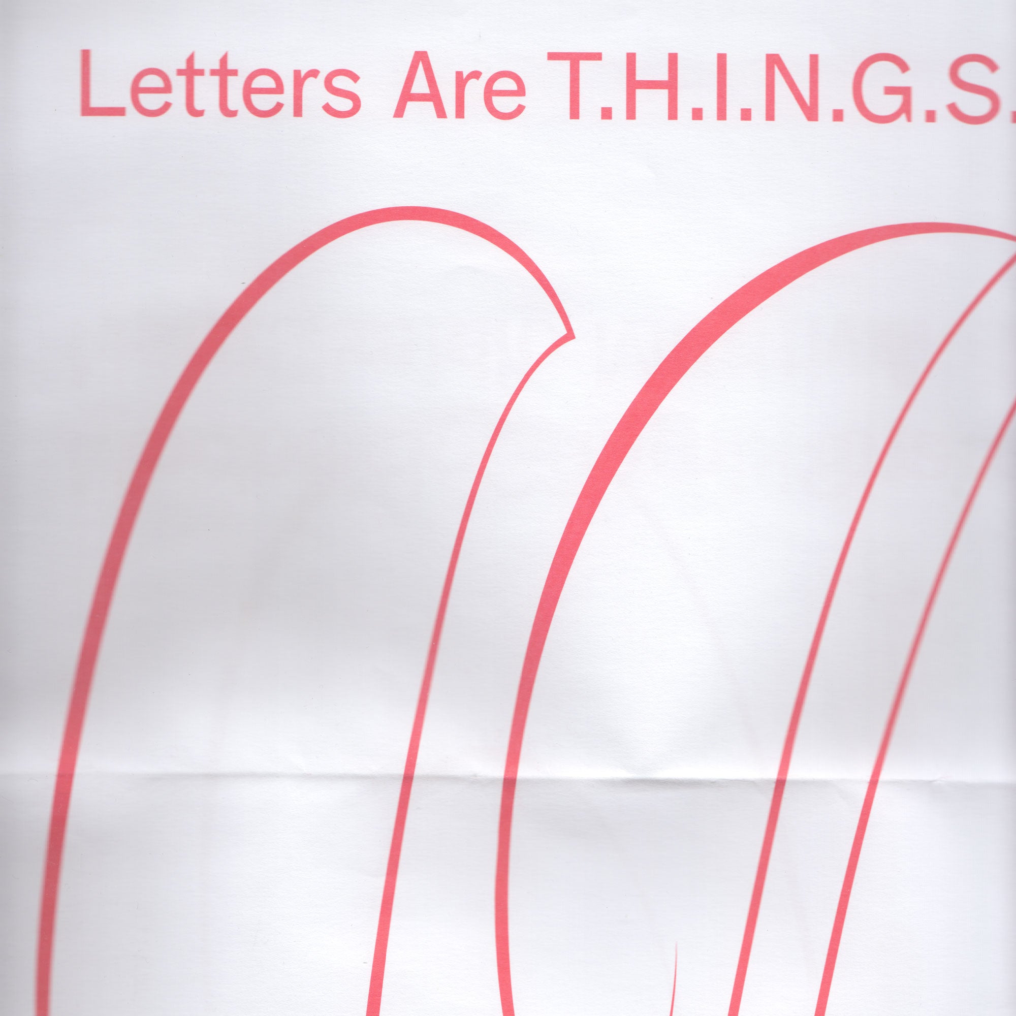 Red abstract curves adorn a folded white paper with the words "Letters Are T.H.I.N.G.S" displayed in red.