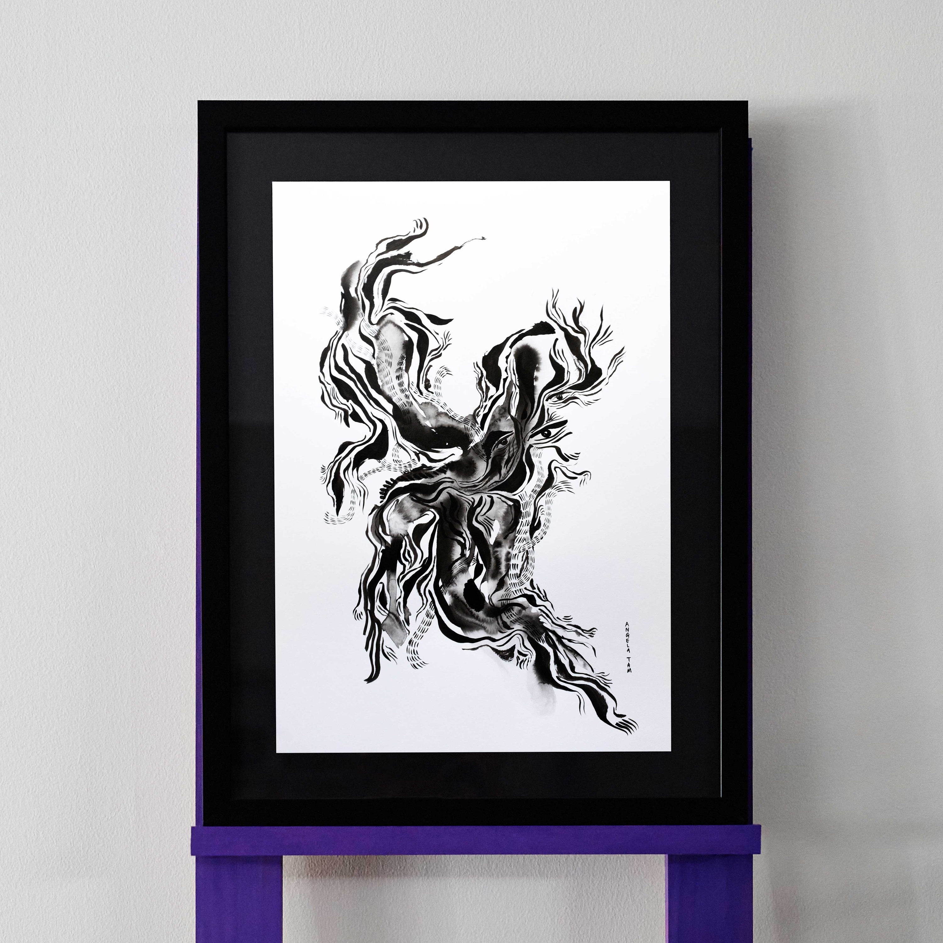 Black and white Chinese ink drawing revealing lines that show eyes and a face. The artwork is pictured in a black frame.