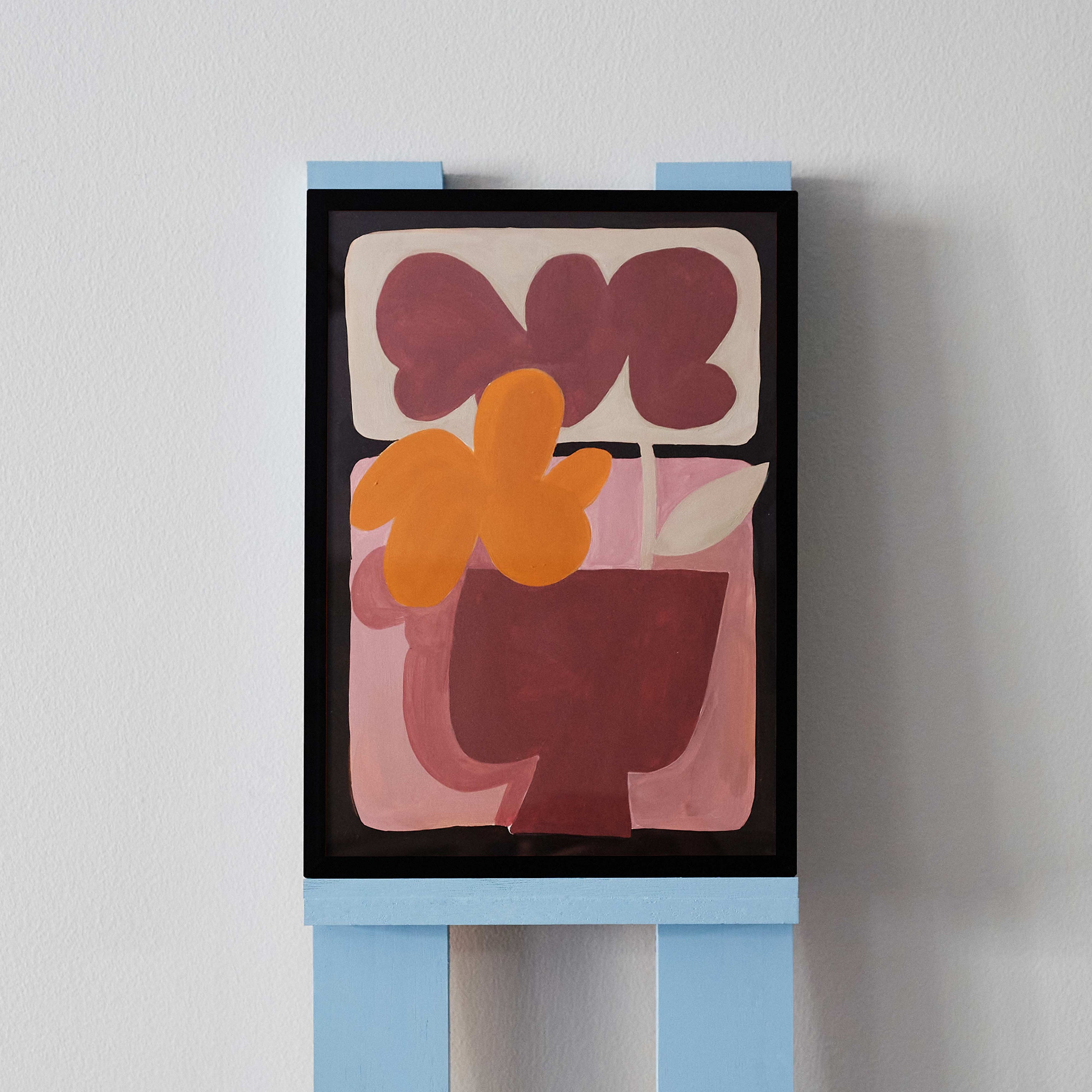 'Flower Arrangement 6' is an original acrylic painting by Angela Tam. Two large and muted coloured flowers sit over pastel boxes in the background, stemming from a small maroon vase. Displayed on a black frame.