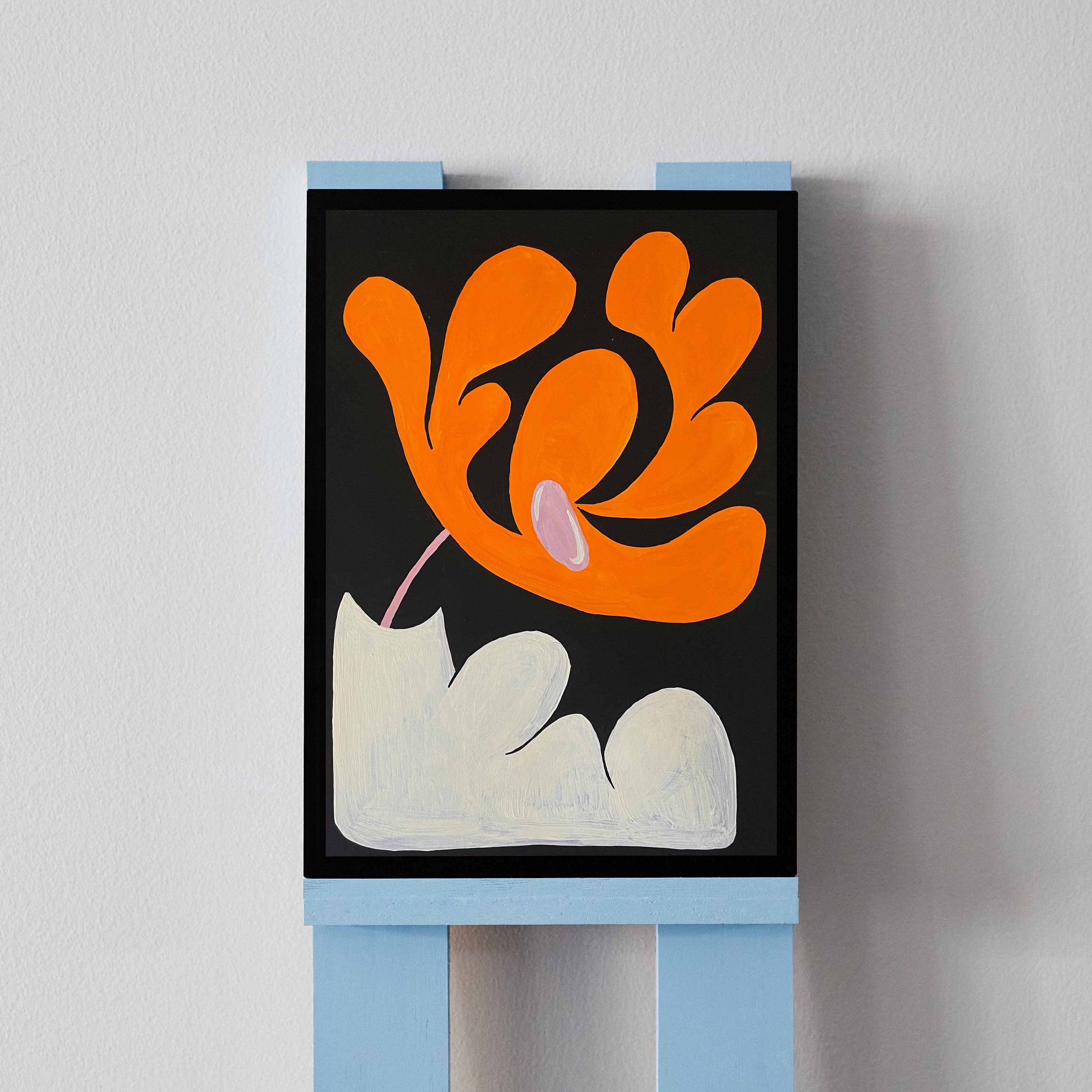 'Flower Arrangement 7' features a heavily abstracted orange flower in a white, lumpy vase. Angela Tam's original acrylic painting is vibrant and bold, with a simple black background to focus on the detailed curved edges of the flower's petals. Displayed on a black frame.