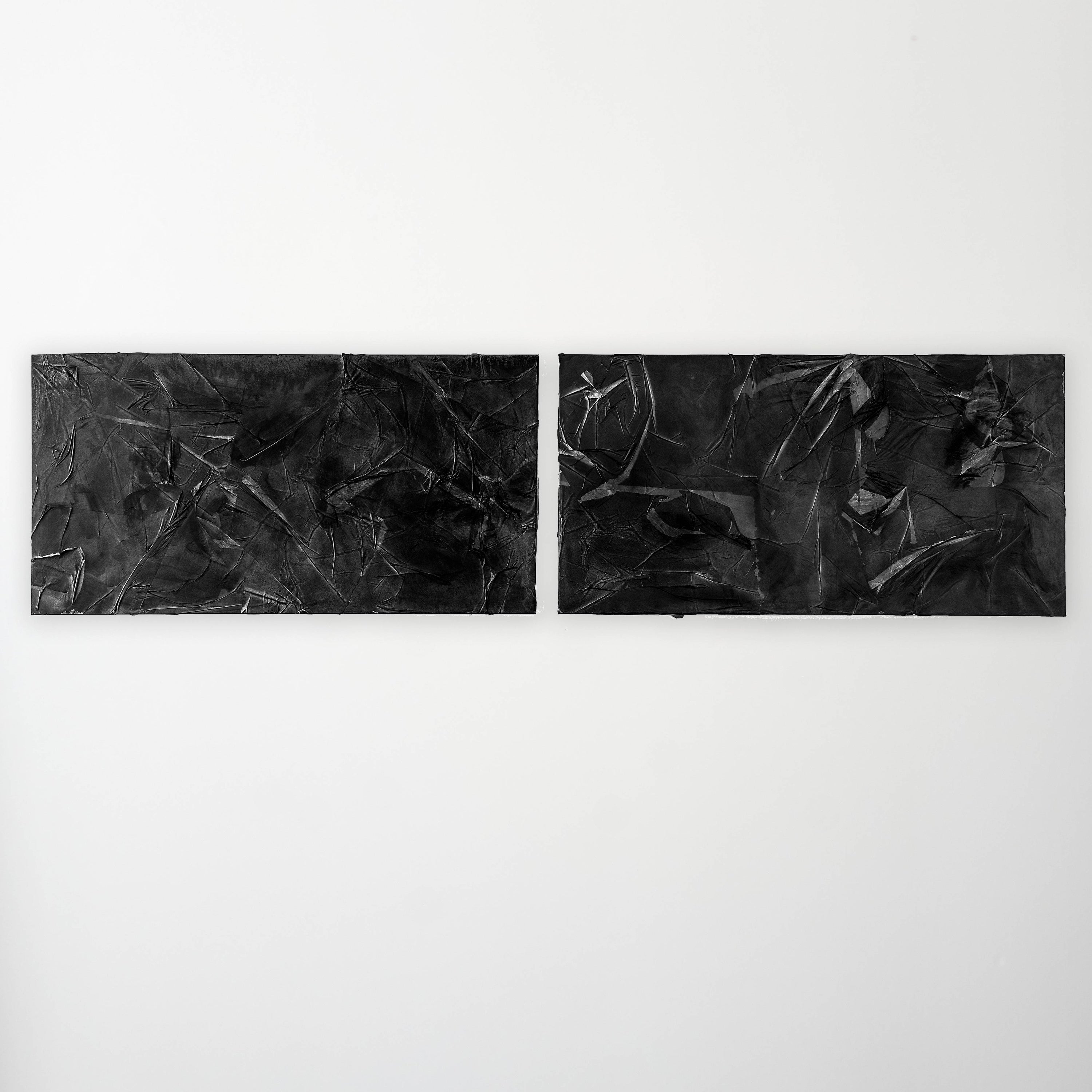 Two abstract paintings hang on the gallery wall as a diptych.