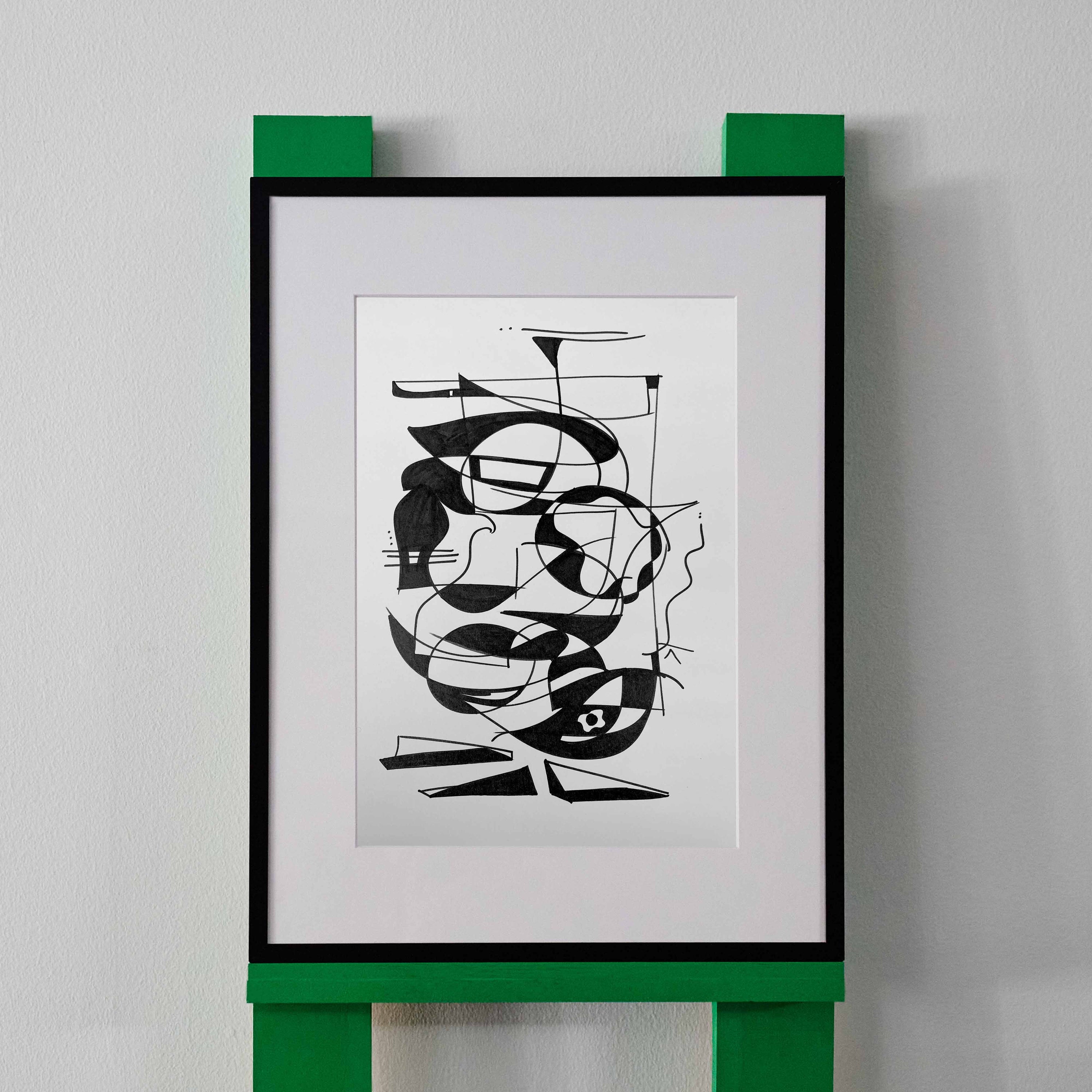 A black and white line drawing by wa sei. The artwork depicts an abstracted pattern of faces and shapes, displayed in a black frame.