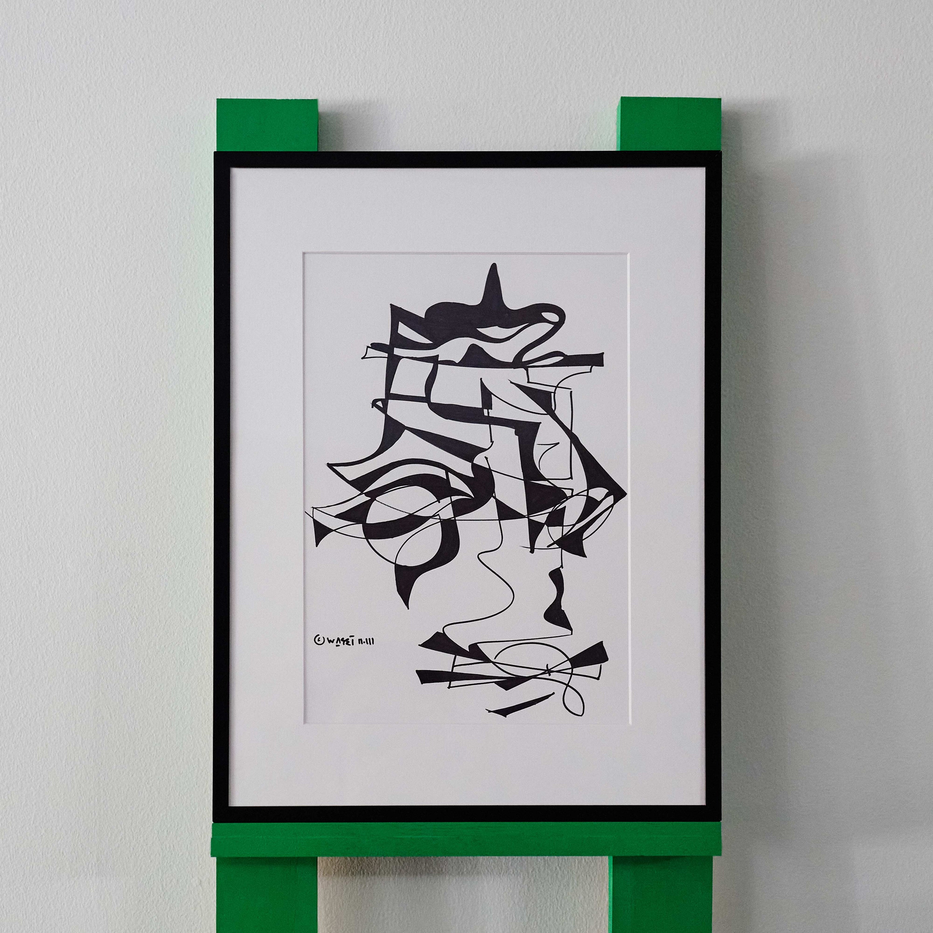 A black and white line drawing by wa sei. The artwork depicts an abstracted pattern of faces and shapes, displayed in a black frame.