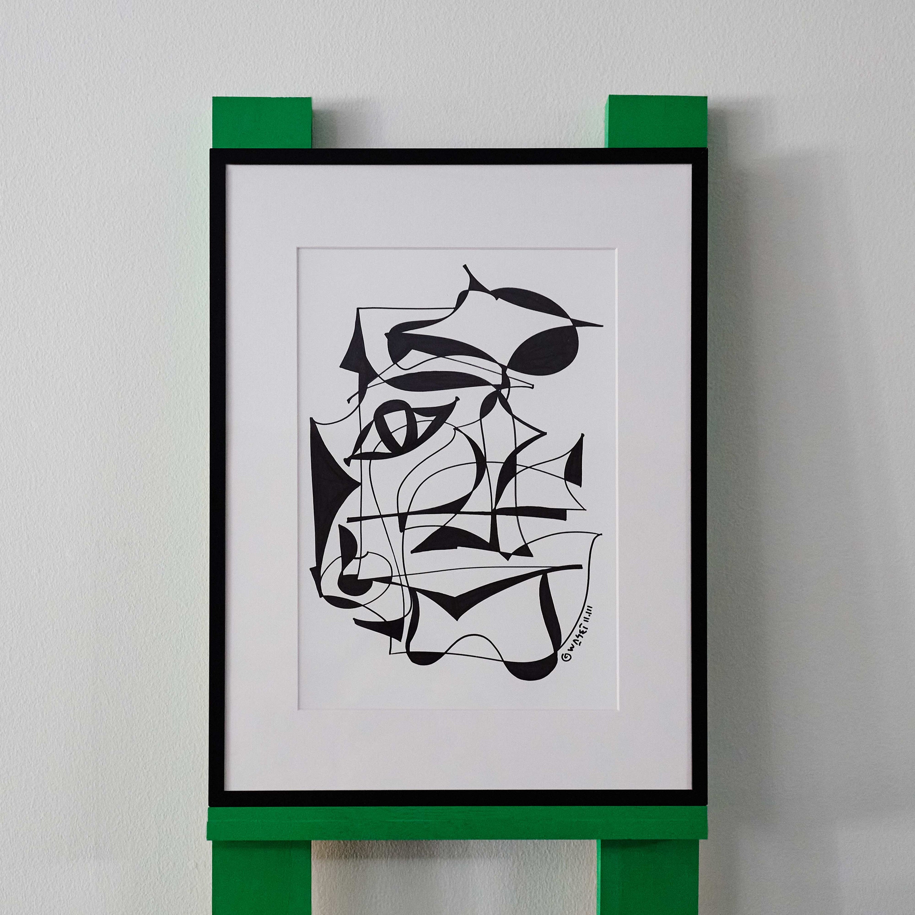 A black and white line drawing by wa sei. The artwork depicts an abstracted eye and shapes, displayed in a sleek black frame.