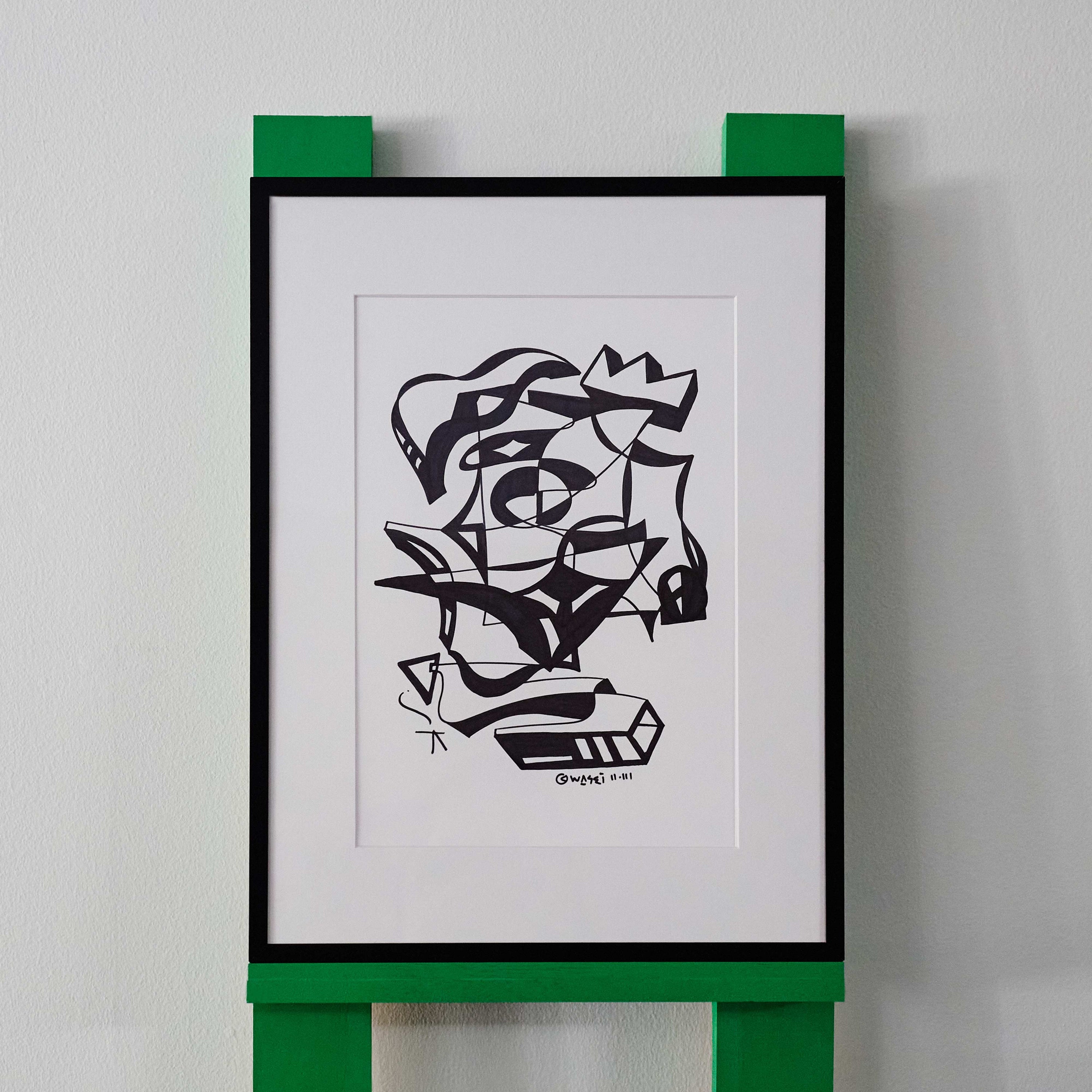 A black and white line drawing by wa sei. The artwork depicts an abstracted eye, crown and 3D shapes, displayed in a sleek black frame.